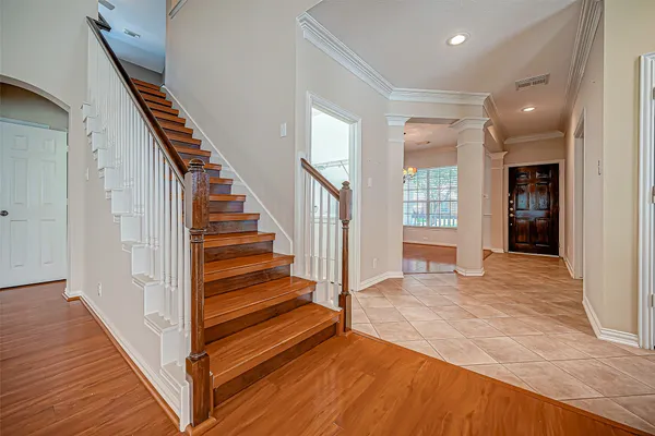 a view of entryway and hall with wooden floor