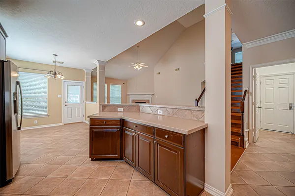 a kitchen with a sink a counter top space stainless steel appliances and cabinets