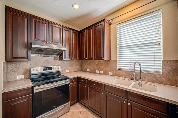 a kitchen with wooden cabinets and a sink
