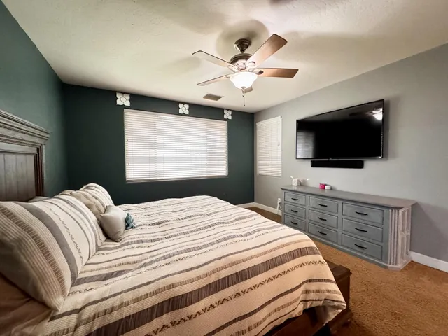 a kitchen with stainless steel appliances granite countertop a sink a stove and refrigerator