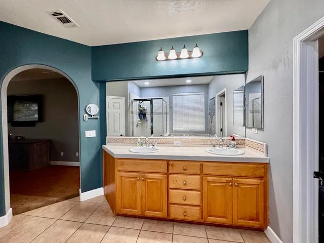 a bedroom with furniture and a large window