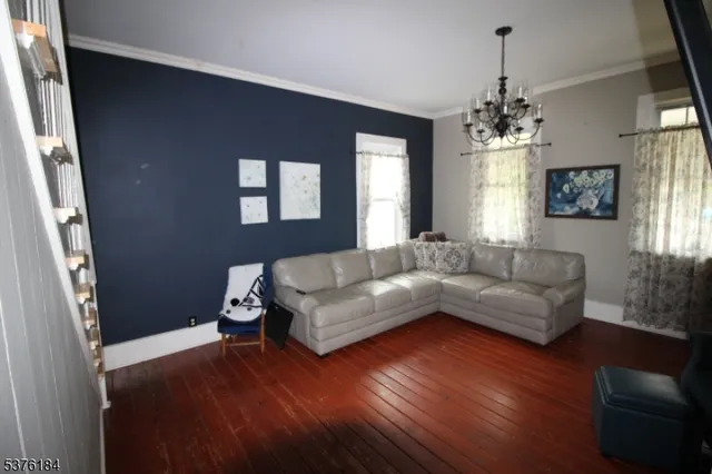a living room with furniture and a chandelier