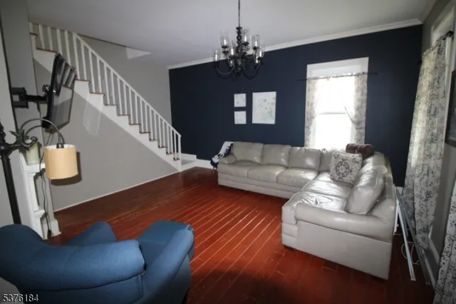 a living room with furniture and a chandelier