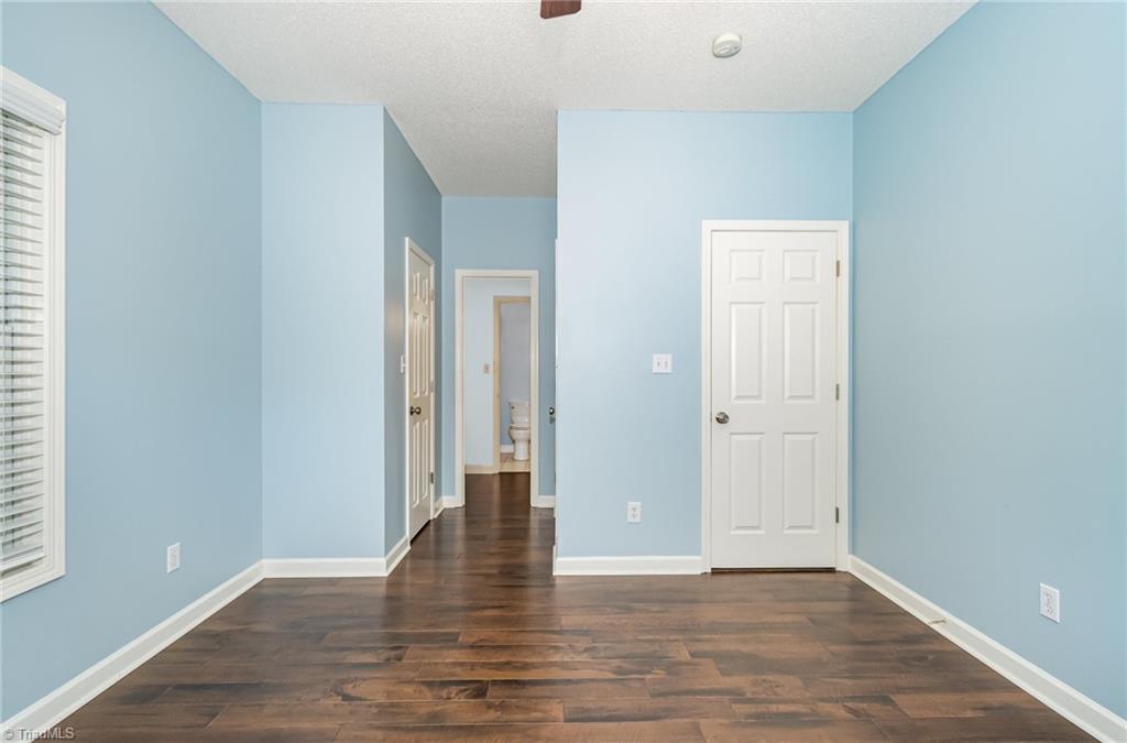 339 Old Burkhart Road Lexington, NC 27292 - Photo 21 of 39 2nd BR is another possible primary type BR w/ dual closets and private vanity area that opens to hall bath-also has an updated walk-in shower installed 2020.