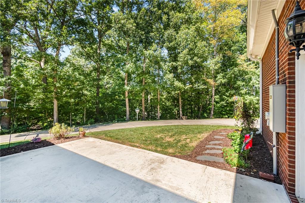 339 Old Burkhart Road Lexington, NC 27292 - Photo 31 of 39 Patio is so inviting and overlooks wooded area of backyard!