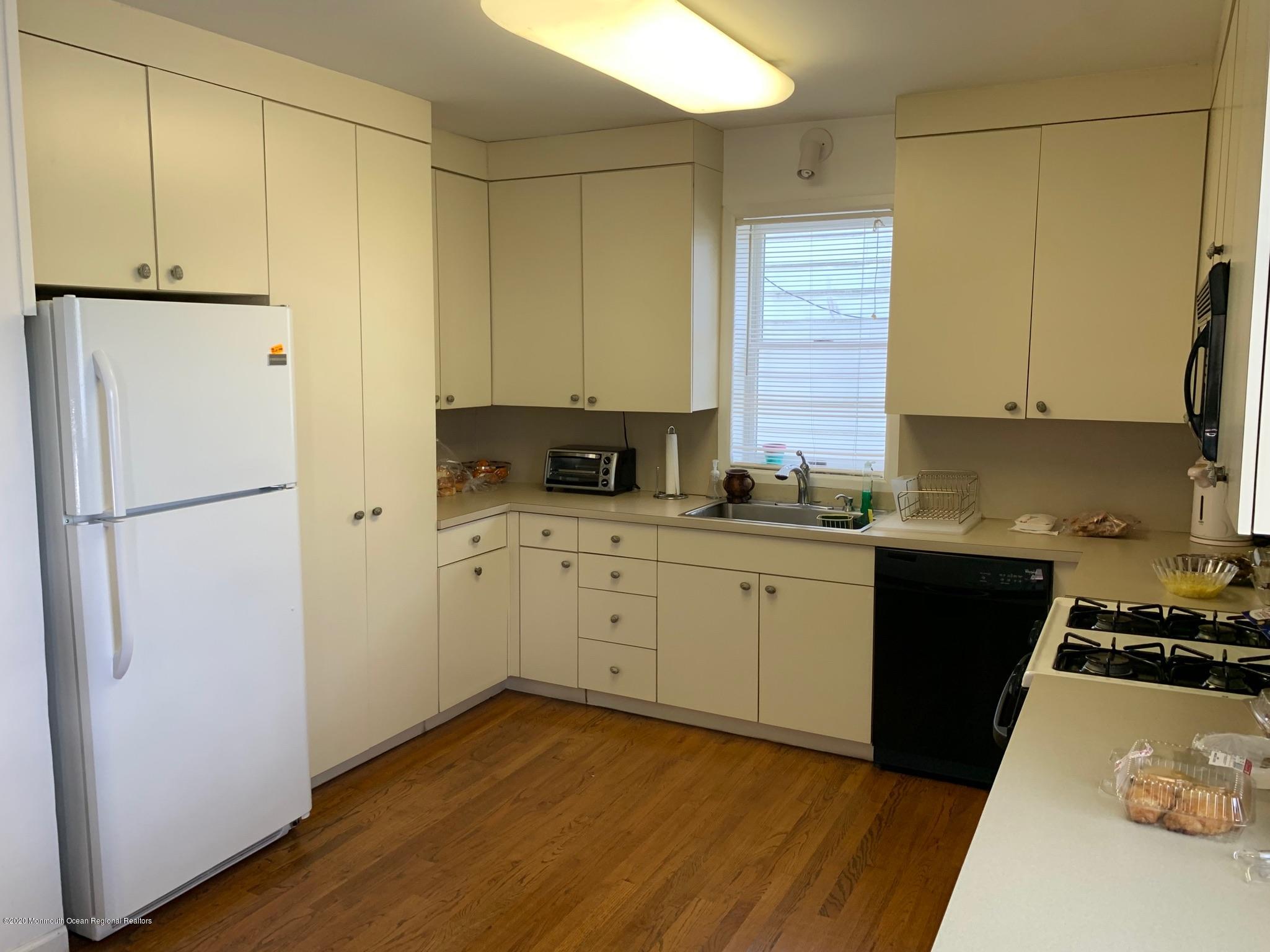 9 Wyckoff Street Deal, NJ 07723 - Photo 4 of 15 a kitchen with a refrigerator and a stove top oven