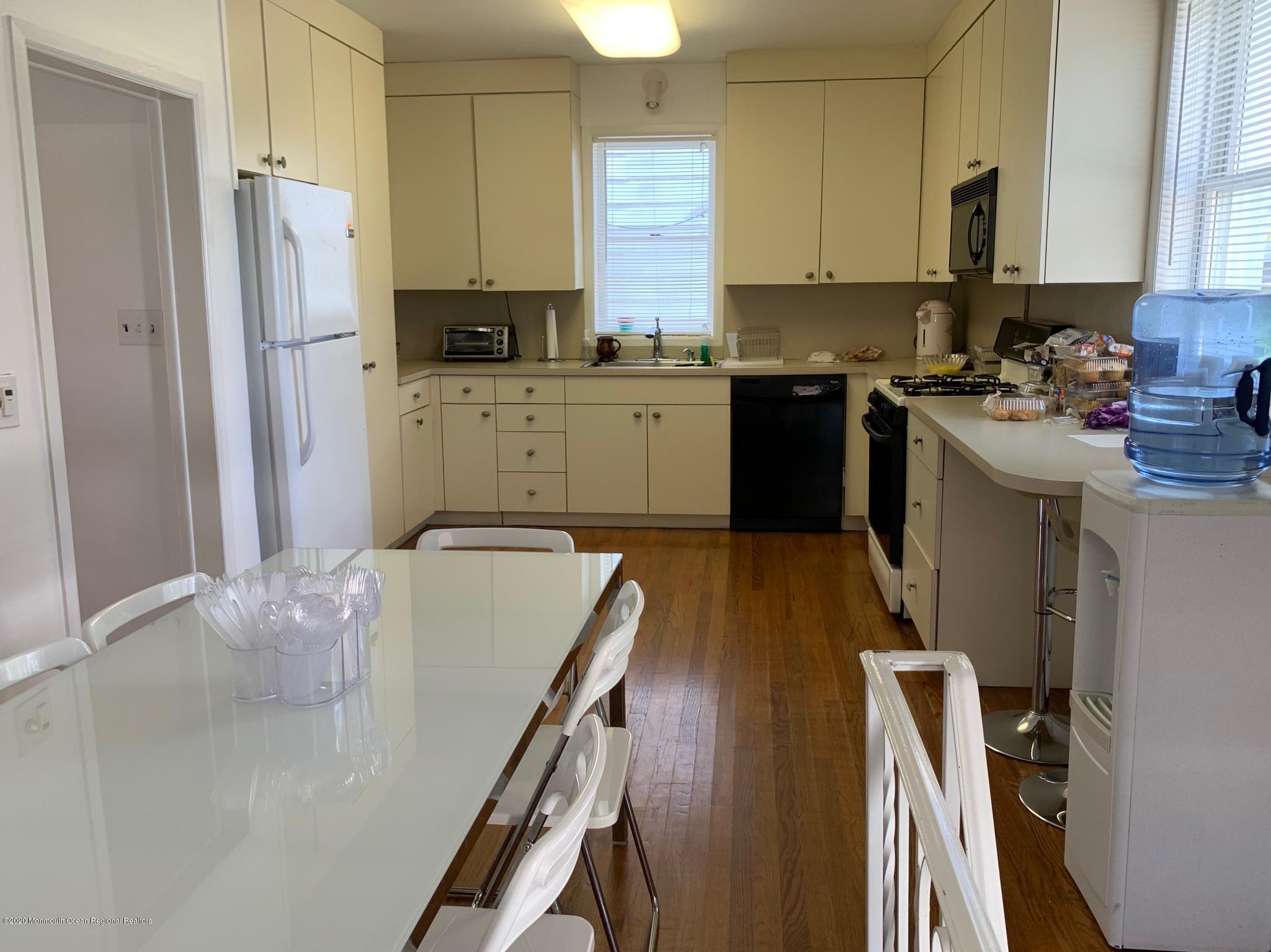 9 Wyckoff Street Deal, NJ 07723 - Photo 5 of 15 a kitchen with a refrigerator a sink a stove a microwave and cabinets