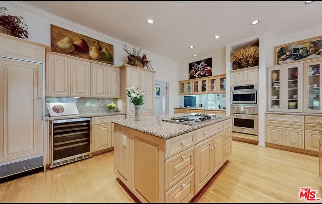 a kitchen with stainless steel appliances granite countertop a stove and a refrigerator