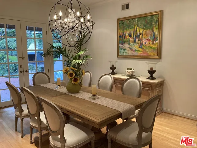 a dining room with furniture and chandelier