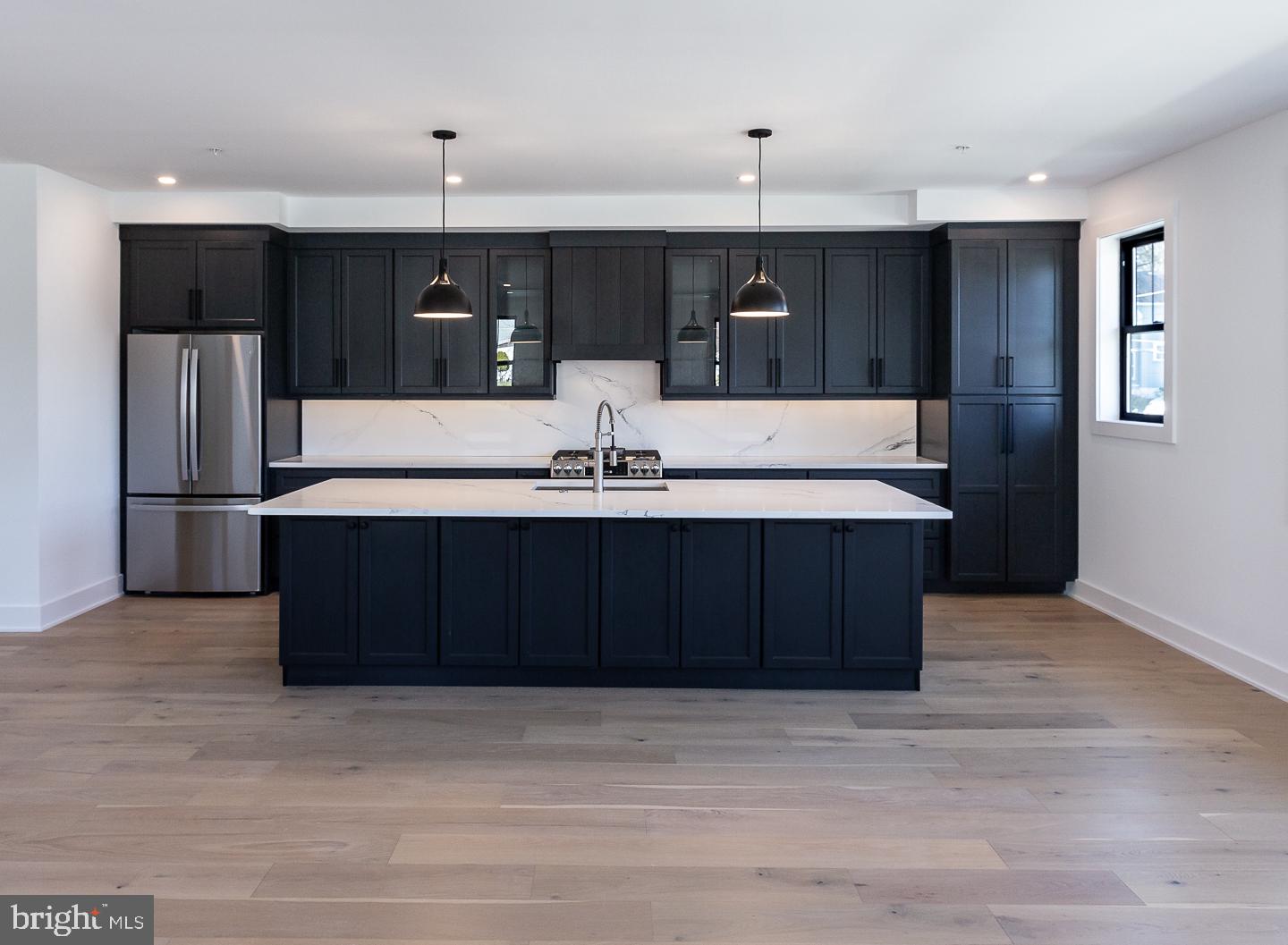 981 Henry Avenue Wayne, PA 19087 - Photo 9 of 32 Sleek modern kitchen with dark cabinetry.