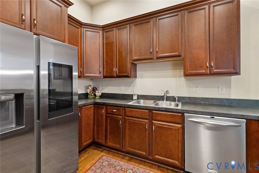 13173 Scotchtown Road Beaverdam, VA 23015 - Photo 26 of 65 a kitchen with stainless steel appliances granite countertop a refrigerator a sink and dishwasher a stove with wooden cabinets