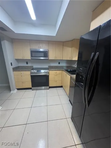 a kitchen with a sink a stove top oven and cabinets