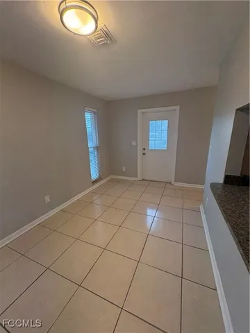 a view of a livingroom with an empty space and a window