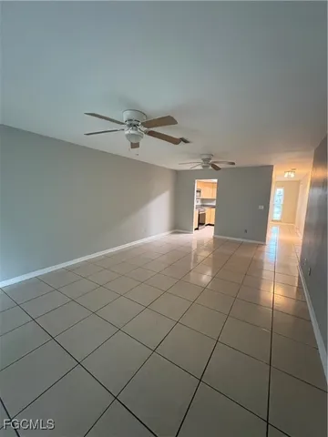 a view of a livingroom with an empty space and a window