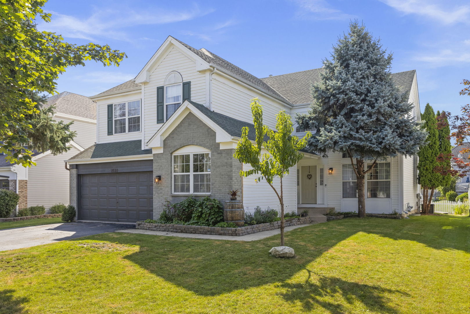 a front view of a house with a yard and garage