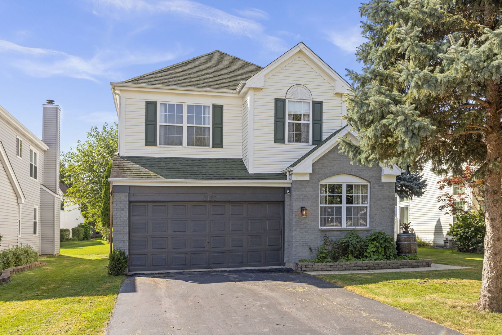 2132 Feldott Lane Naperville, IL 60540 - Photo 28 of 33 a front view of a house with a yard and garage