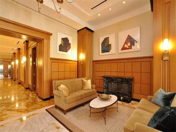 a view of a lobby with a chandelier furniture and windows