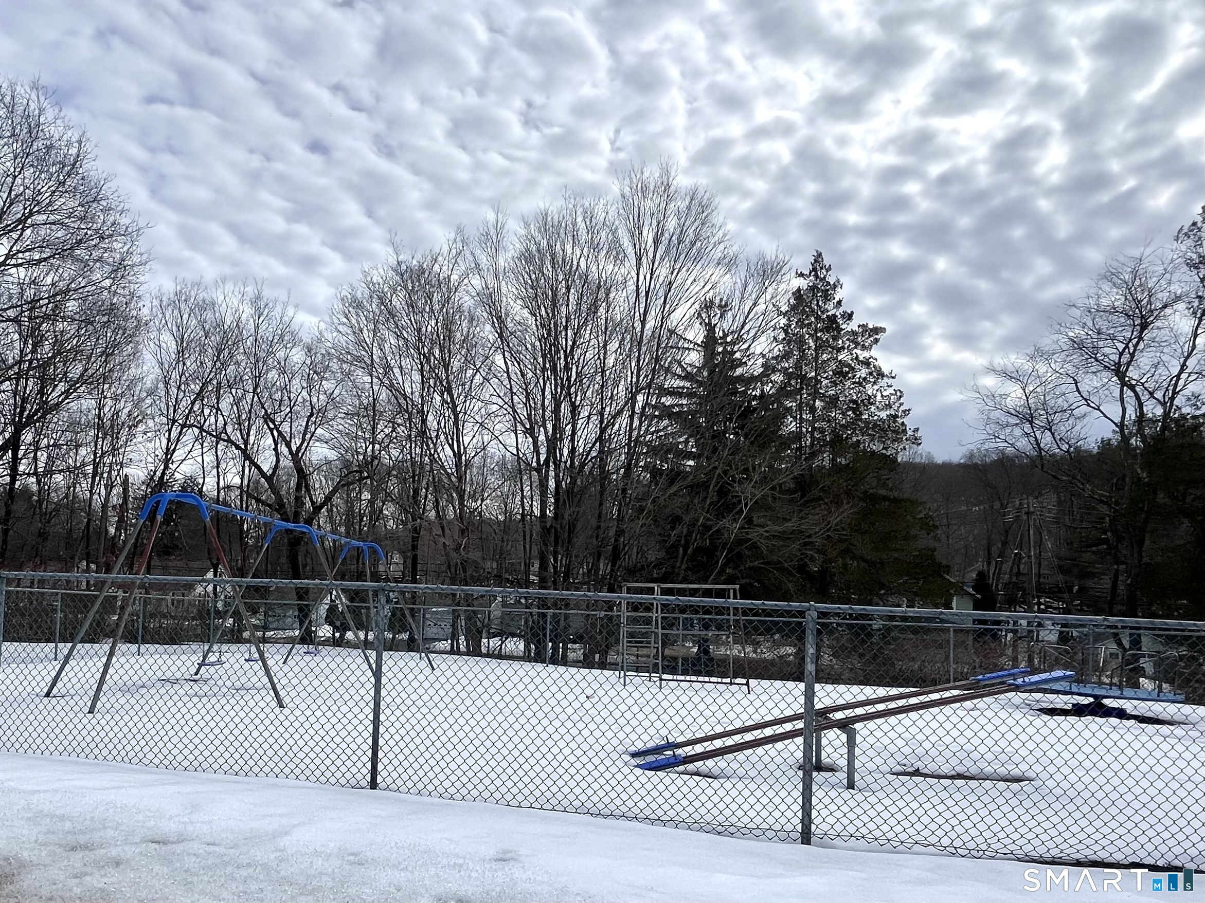 1081 New Haven Road, Unit 11J Naugatuck, CT 06770 - Photo 16 of 17 a view of a tennis court with trees in the background