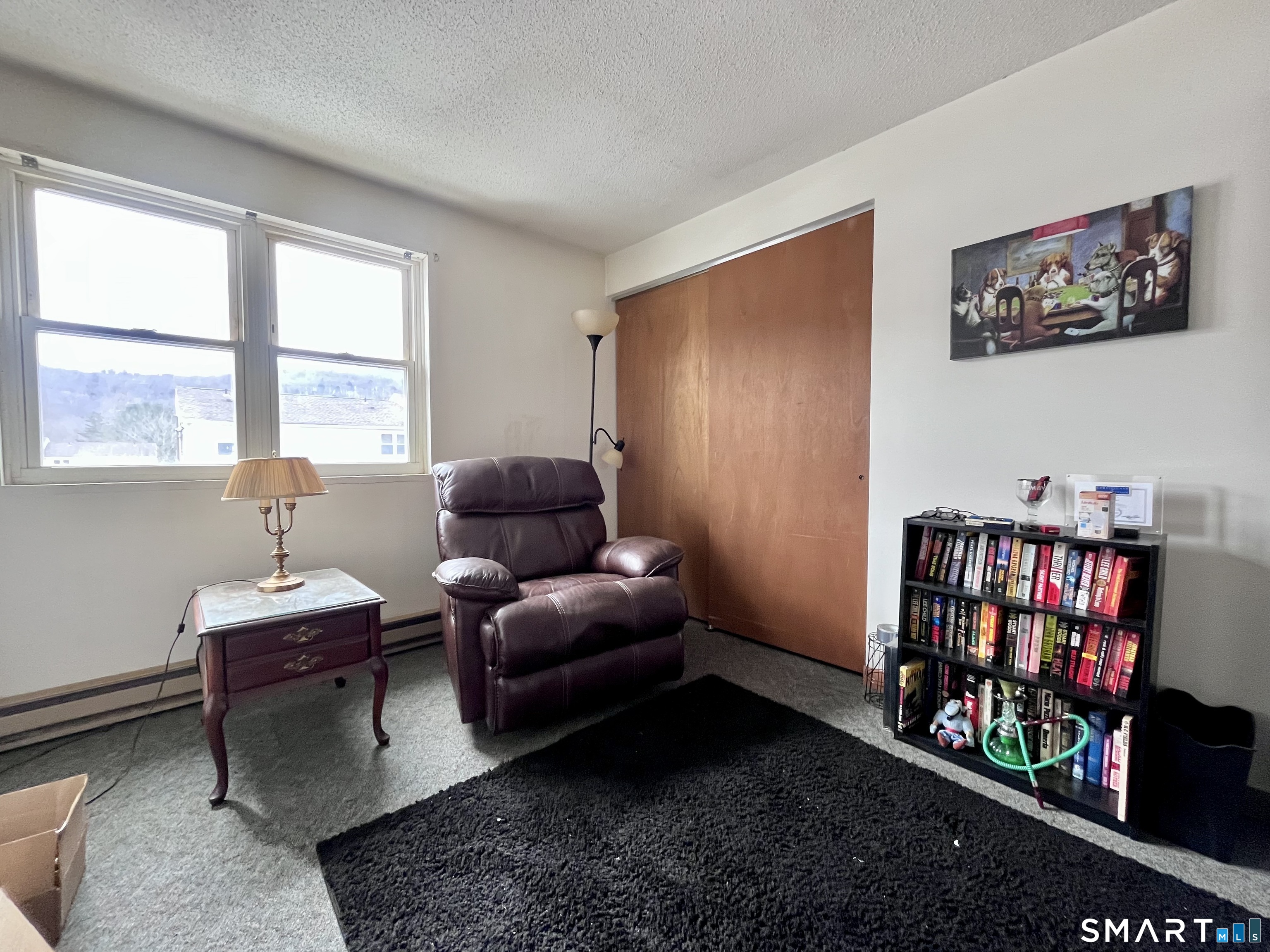 1081 New Haven Road, Unit 11J Naugatuck, CT 06770 - Photo 10 of 17 a living room with furniture window and a book shelf