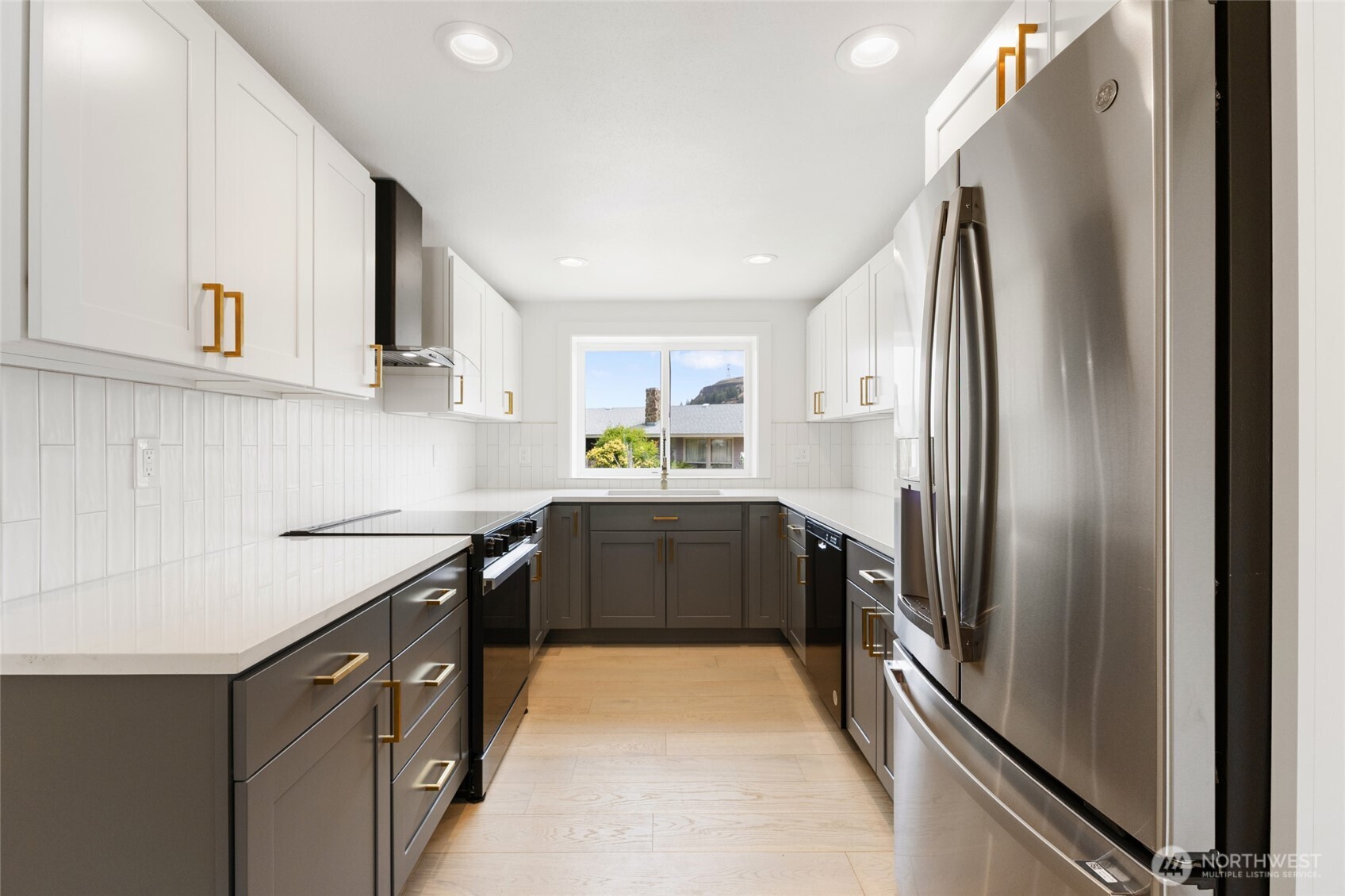 77 Diamond Street Electric City, WA 99123 - Photo 12 of 40 a kitchen with stainless steel appliances granite countertop a refrigerator a sink dishwasher a stove and white cabinets with wooden floor