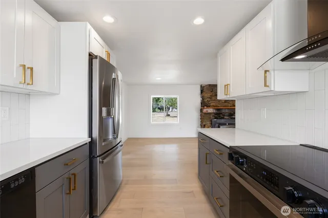 a kitchen with stainless steel appliances a sink a stove and a refrigerator