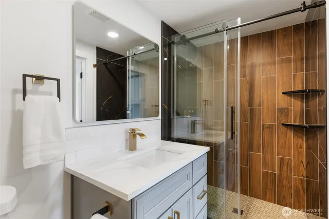 a bathroom with a shower sink and mirror