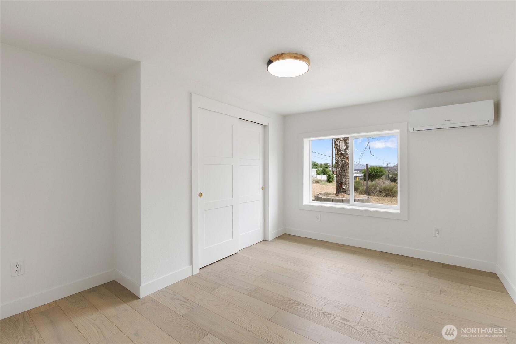 77 Diamond Street Electric City, WA 99123 - Photo 22 of 40 a view of an empty room with window and wooden floor