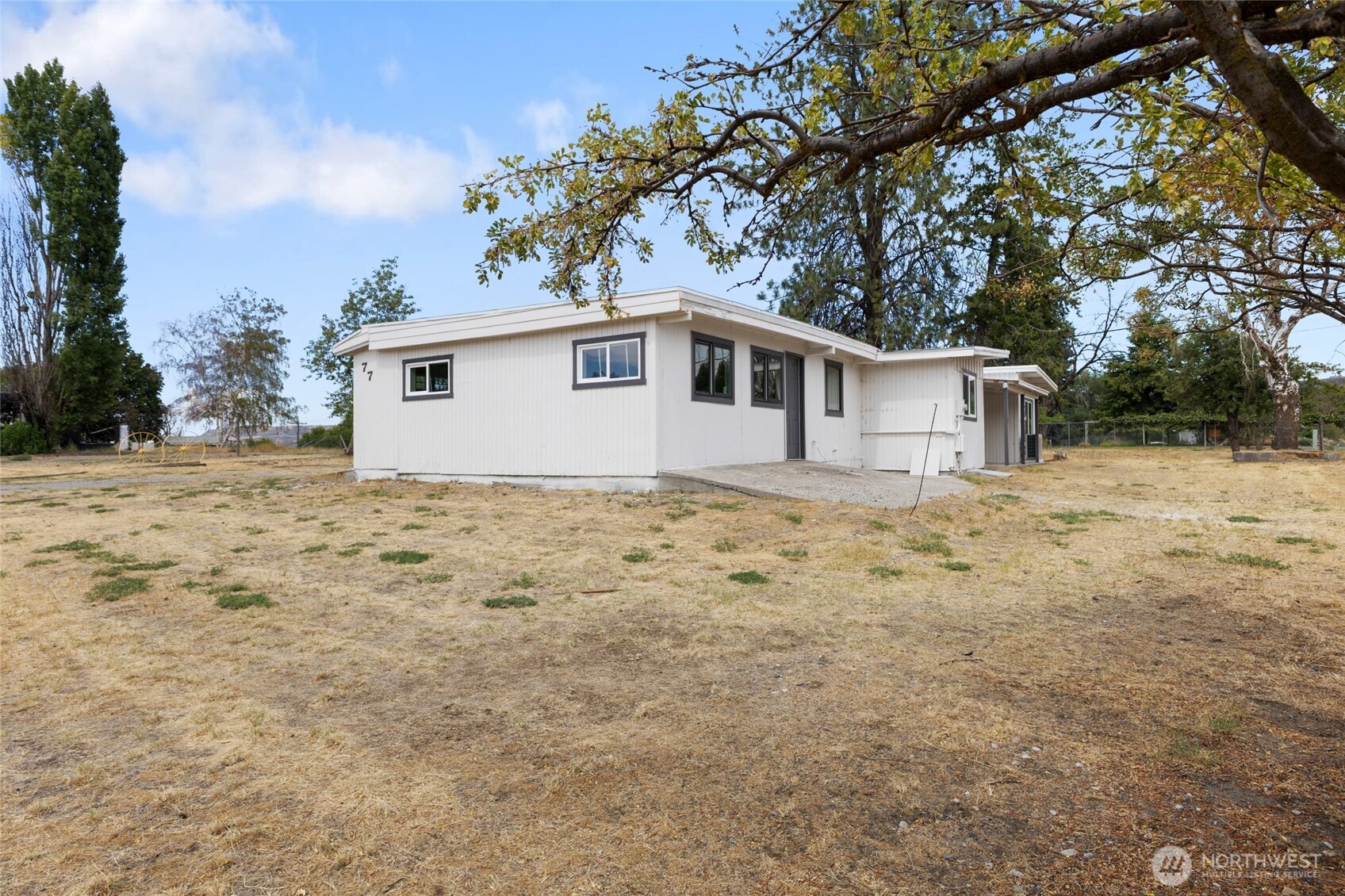 77 Diamond Street Electric City, WA 99123 - Photo 34 of 40 a white house that has a tree in front of it