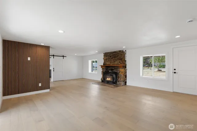 an empty room with furniture and a fireplace