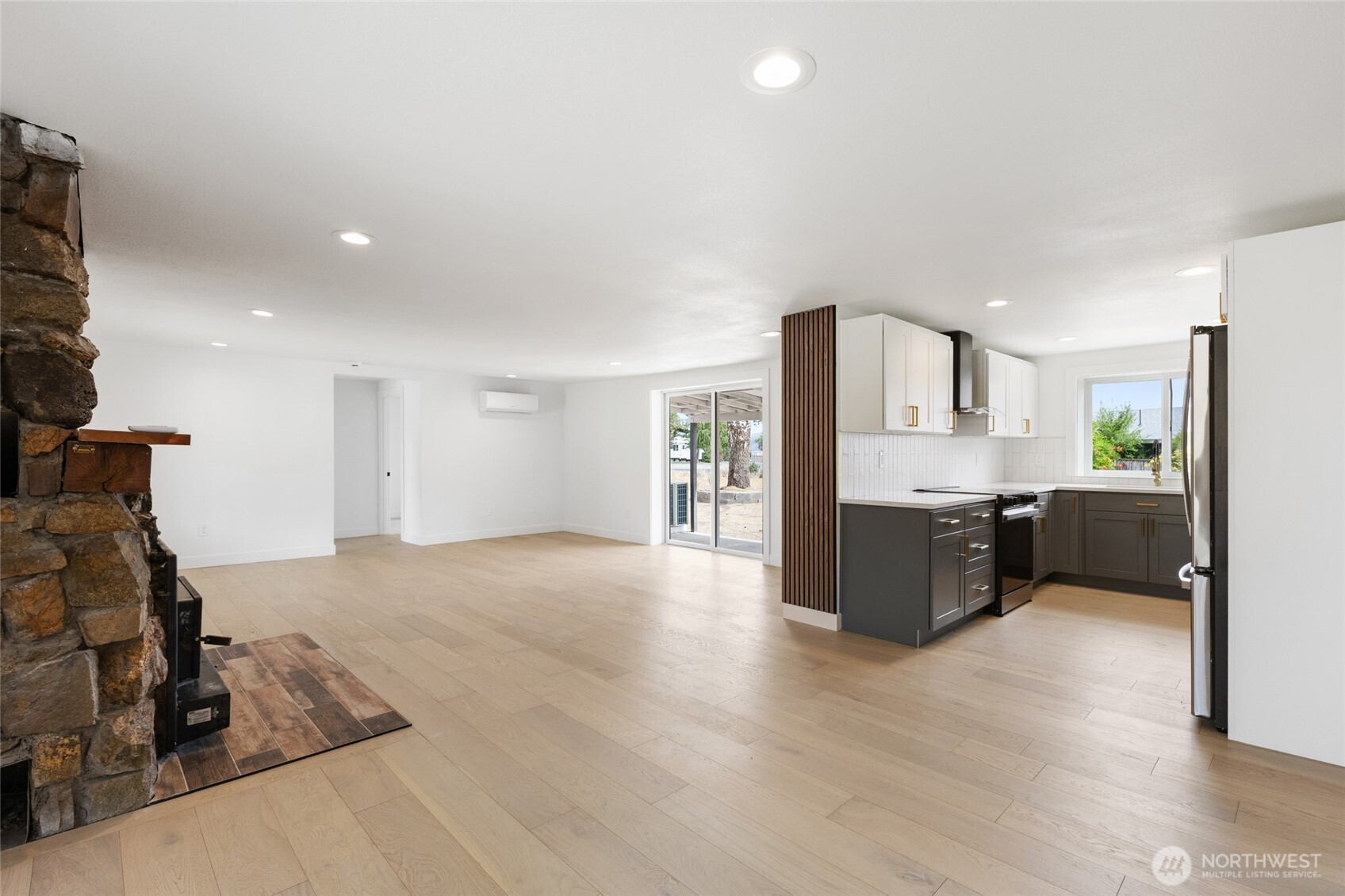77 Diamond Street Electric City, WA 99123 - Photo 9 of 40 a large white kitchen with a refrigerator a sink dishwasher and a stove with wooden floor