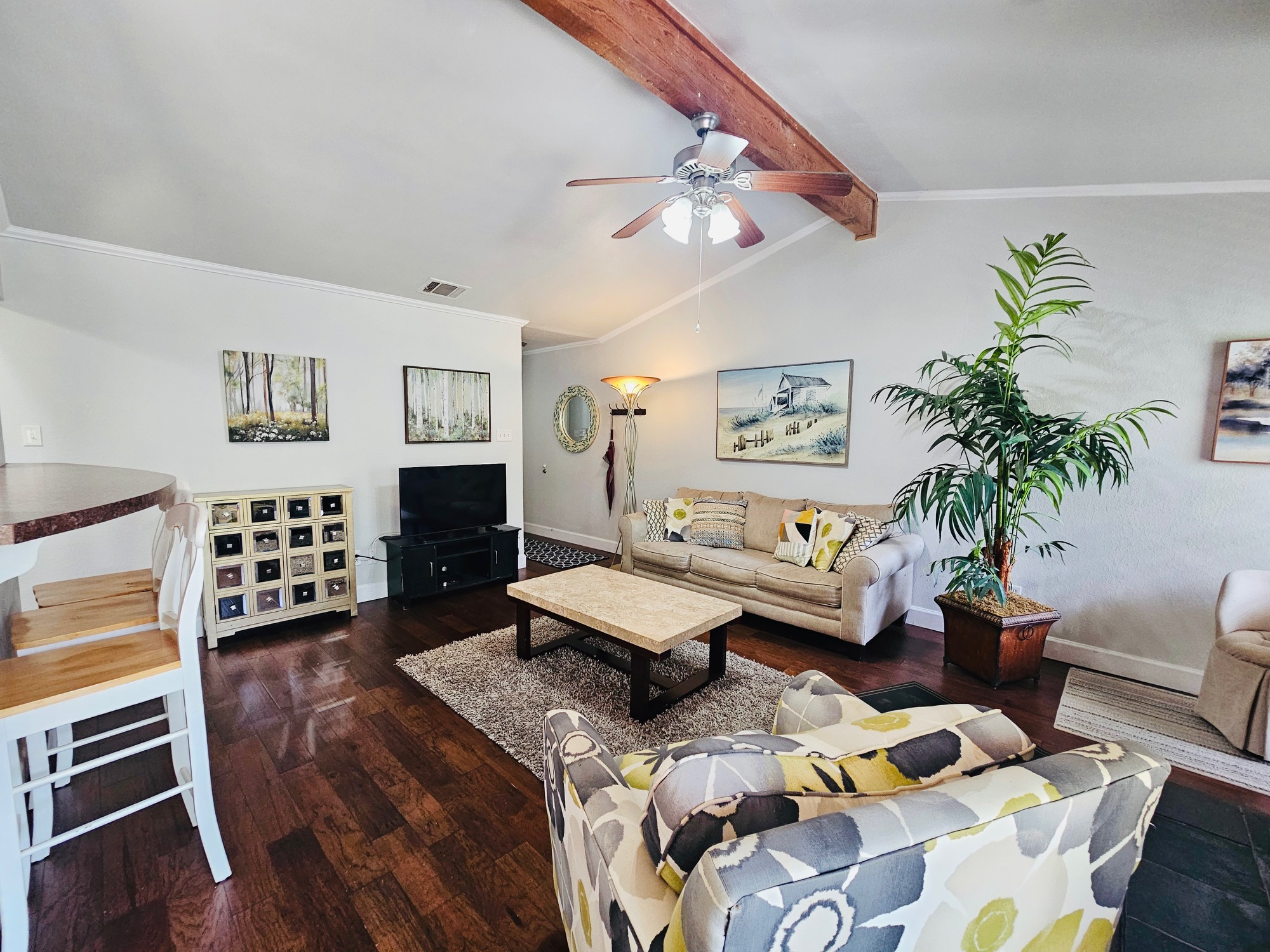 5107 Leralynn Street, Unit 304 Austin, TX 78751 - Photo 1 of 28 Living room featuring lofted ceiling with beams, ceiling fan, ornamental molding, and Dark Hardiplank floors