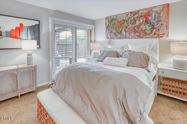 a bedroom with a bed and a painting on the wall