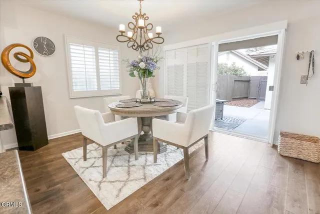 a view of a dining room with furniture wooden floor and chandelier