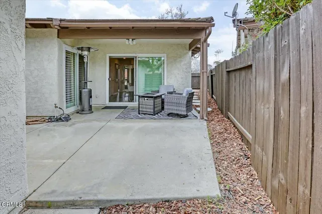 a view of a dinning room with a bench and wooden fence