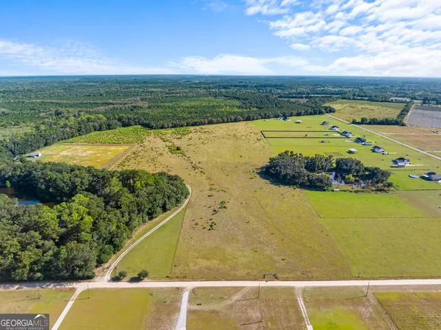 a view of a lake with houses in the background
