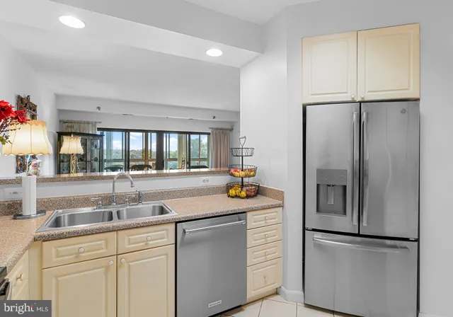 a kitchen with stainless steel appliances granite countertop a refrigerator and a sink