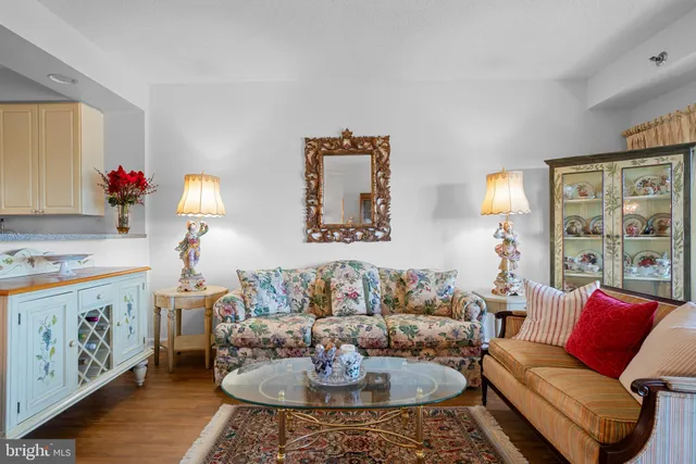 a living room with furniture and painting on the wall