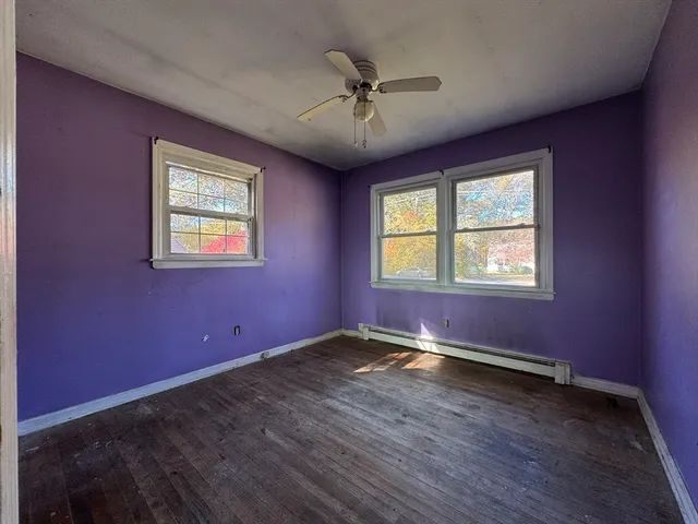 a view of an empty room window and wooden floor
