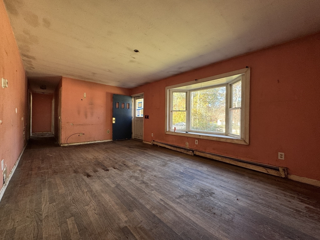 126 Alton Bradford Road Hopkinton, RI 02808 - Photo 13 of 19 a view of an empty room with wooden floor and a window