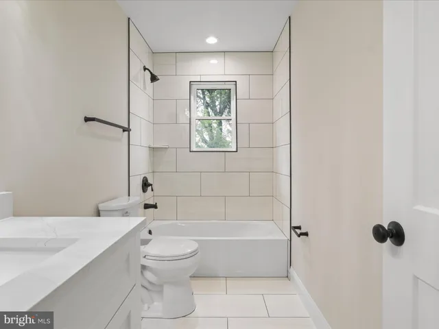a bathroom with a toilet a sink and shower