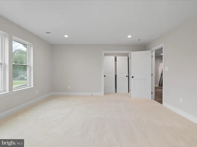a view of an empty room with a kitchen