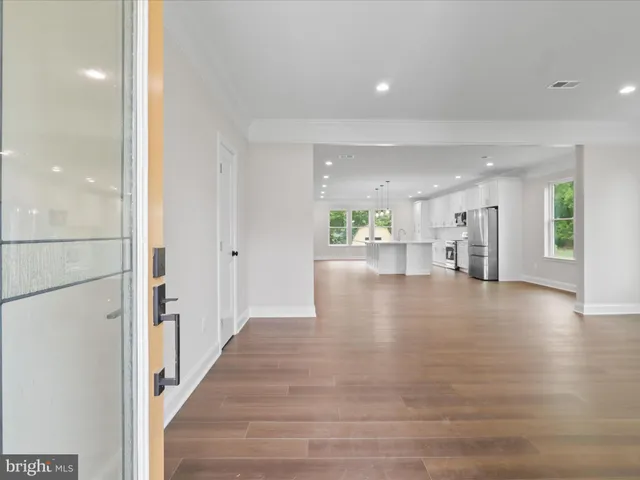 a view of an empty room and a kitchen counter top space