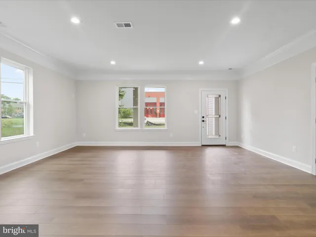 a view of a kitchen with a refrigerator and a stove top oven
