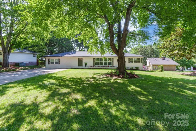 a view of house with yard and green space