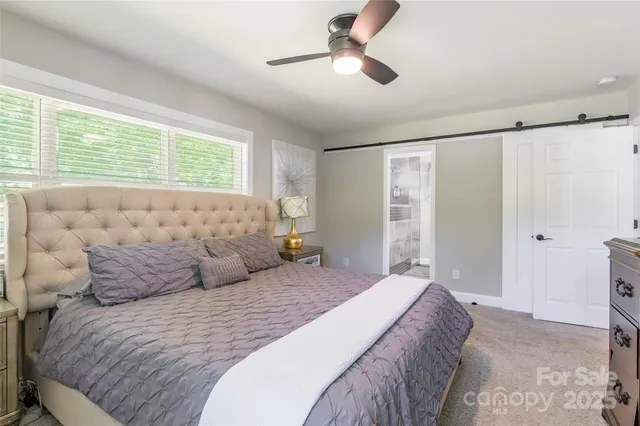 a bedroom with a large bed and a large window