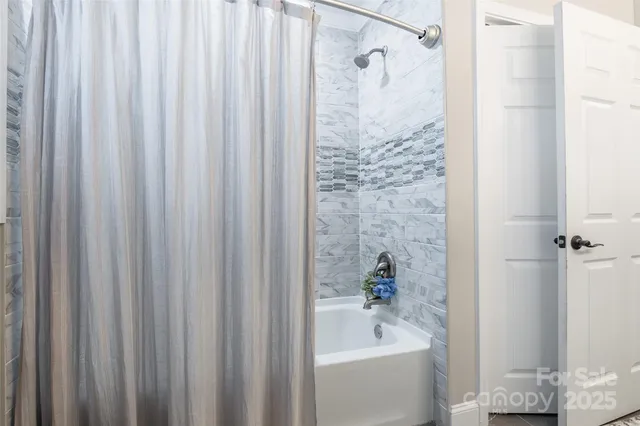 a bathroom with a bathtub and shower