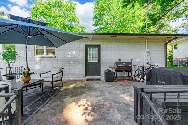 an outdoor space with furniture and umbrella
