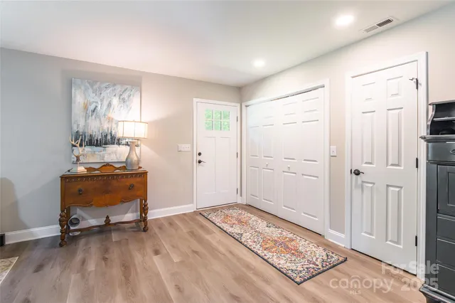 a view of a room with wooden floor and a window