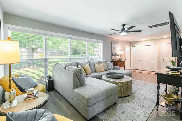 a living room with furniture and a large window
