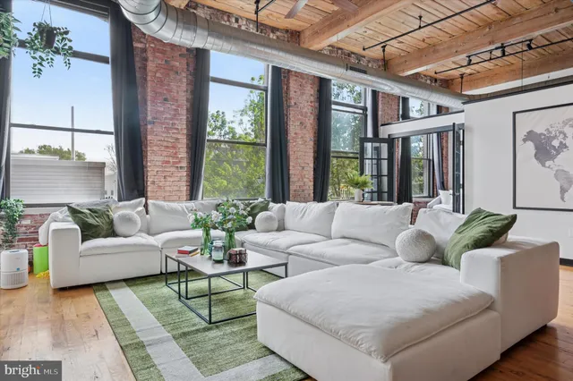 a living room with furniture and large windows